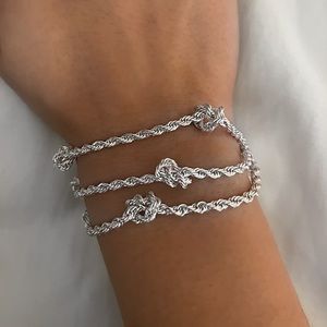 Silver tone multi-chain knotted link bracelet